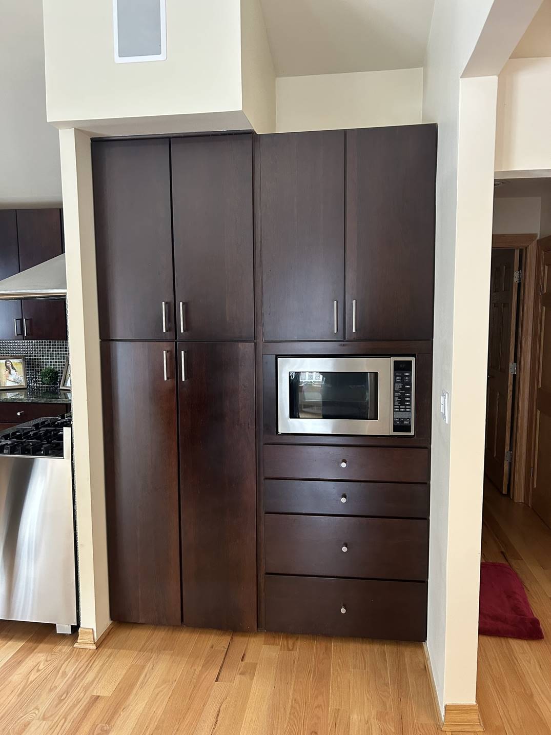 Custom dark cabinetry surrounding a built-in microwave