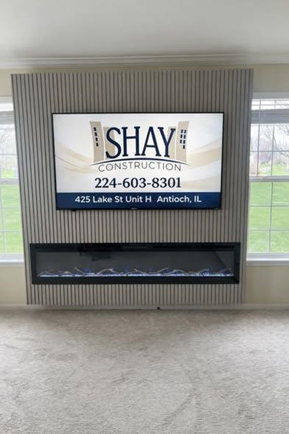 Completed linear fireplace wall with a mounted SHAY sign