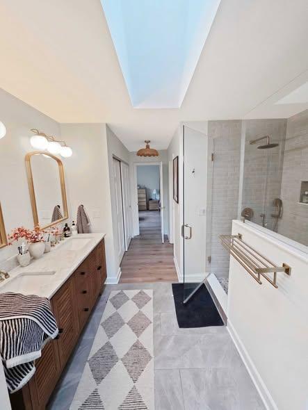 Bathroom renovation with a double vanity and skylight